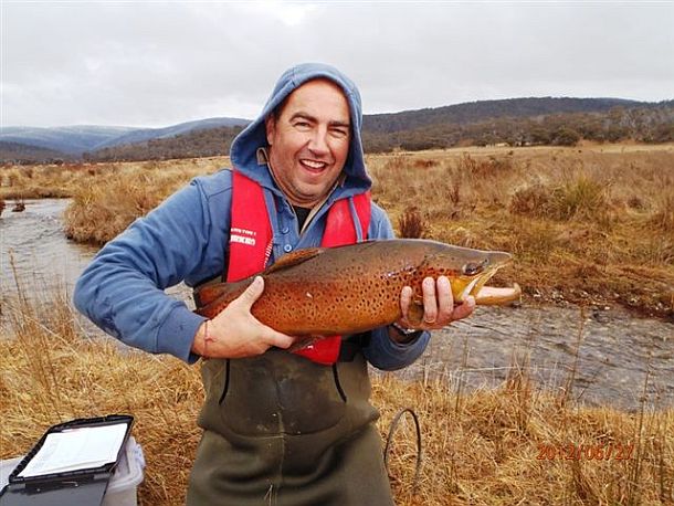 Chris Cleaver with his recently caught and released hybrid cod he likes to call a Murrout (cross between a Murray and trout cod).